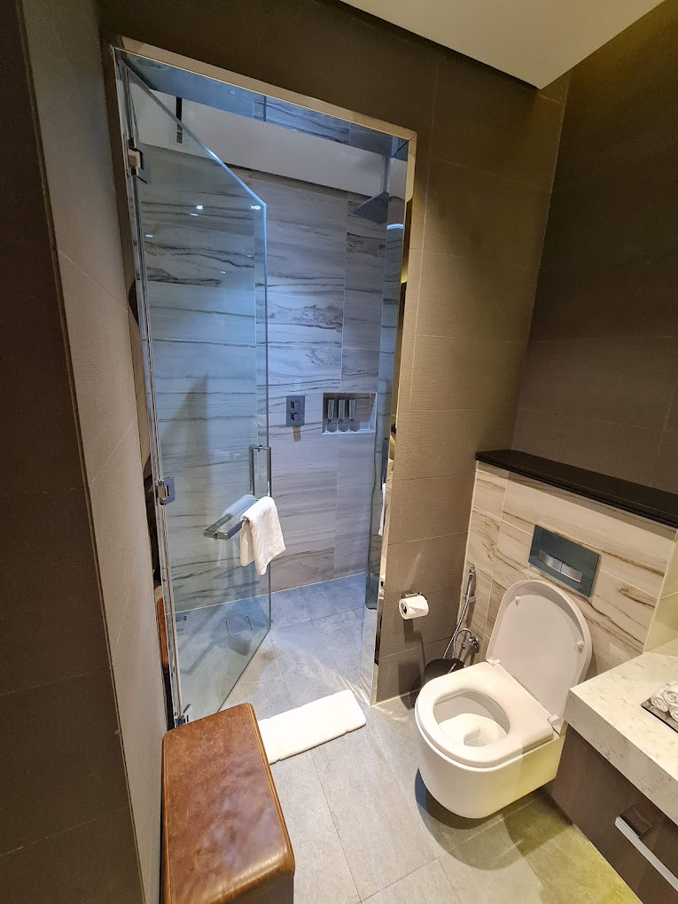 a bathroom with a glass door and a toilet