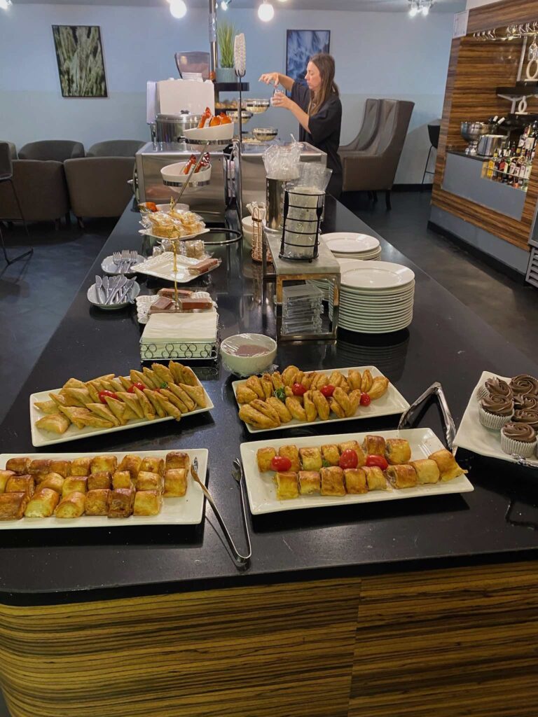 a buffet table with plates of food