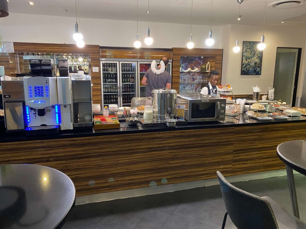 a man standing behind a counter with food on it