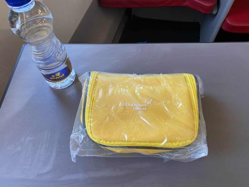 a yellow bag and a bottle of water on a table