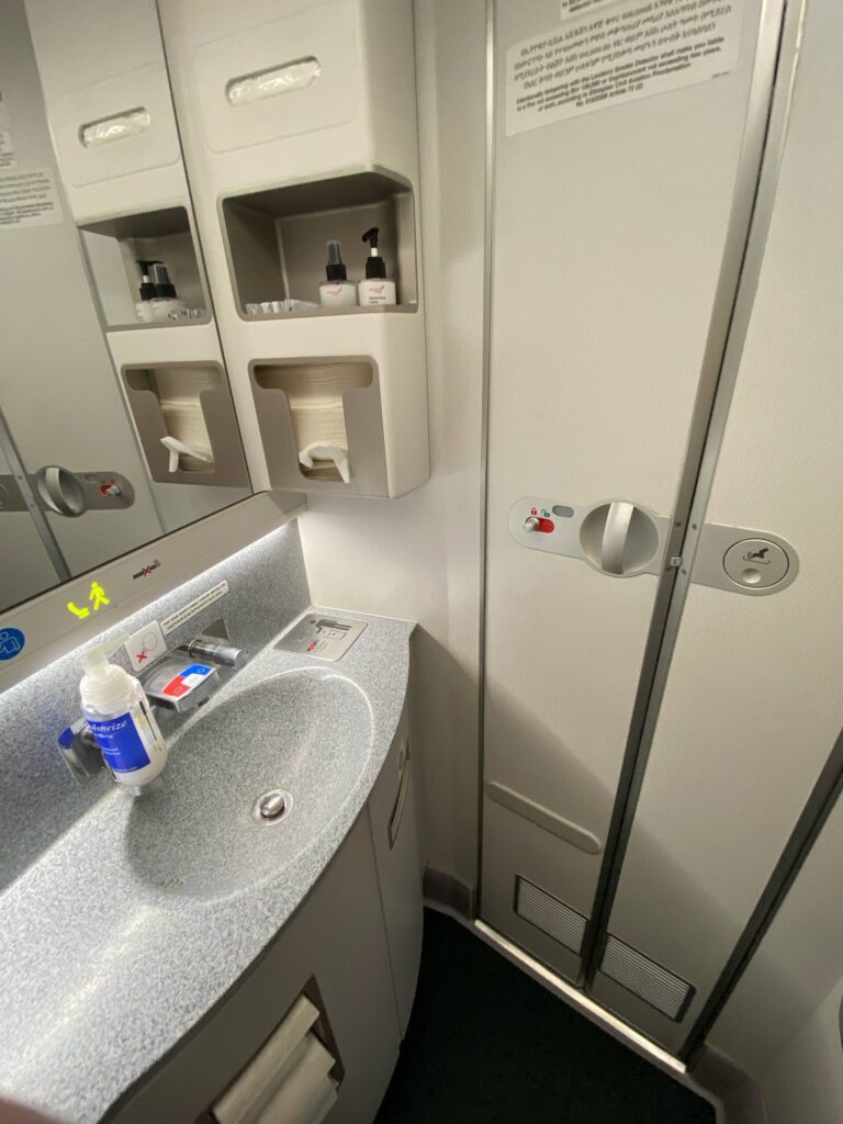 a sink and soap dispenser in a bathroom