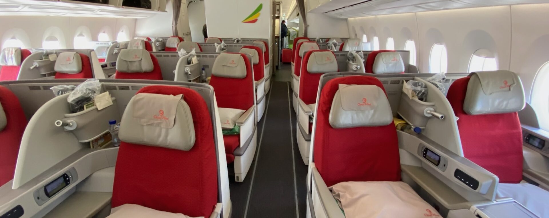 a row of red and white seats on an airplane