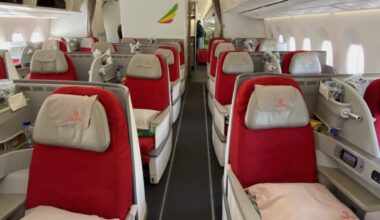 a row of red and white seats on an airplane