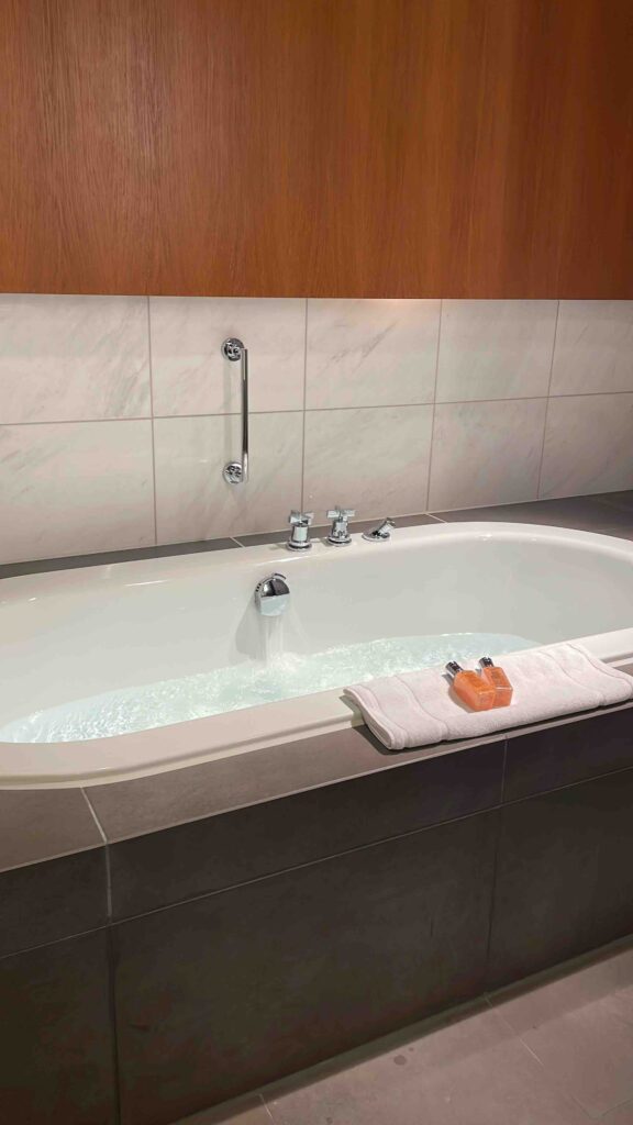 a bathtub with a towel on the side