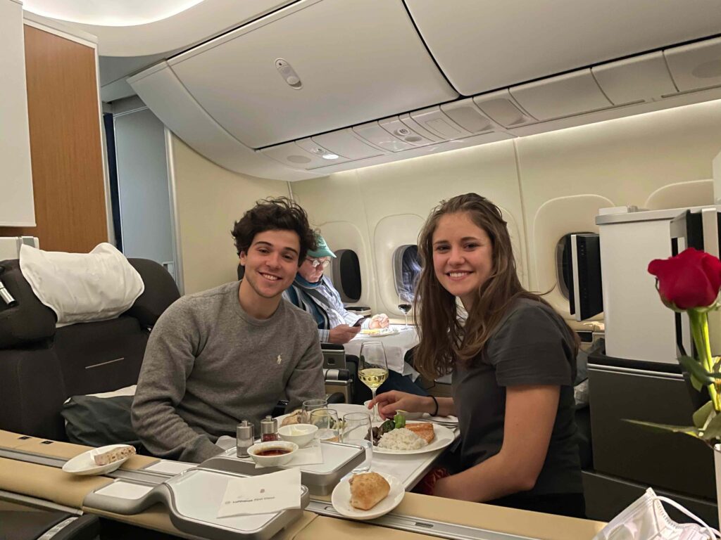 a man and woman sitting at a table with food on it