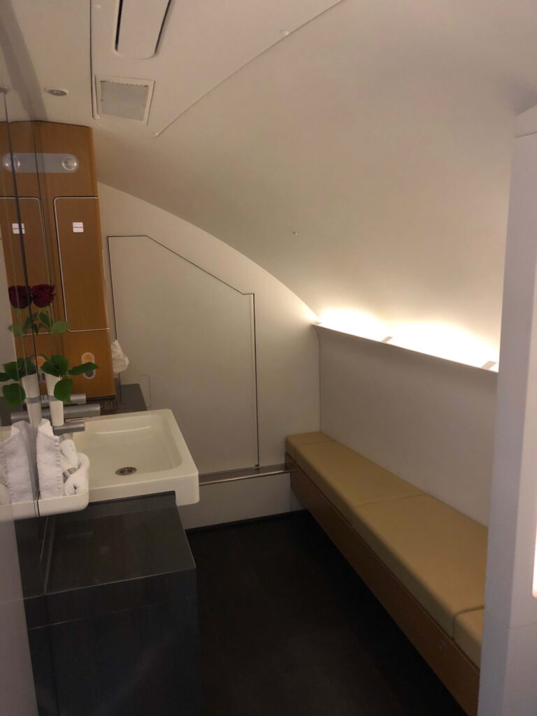 a bathroom with a sink and a bench