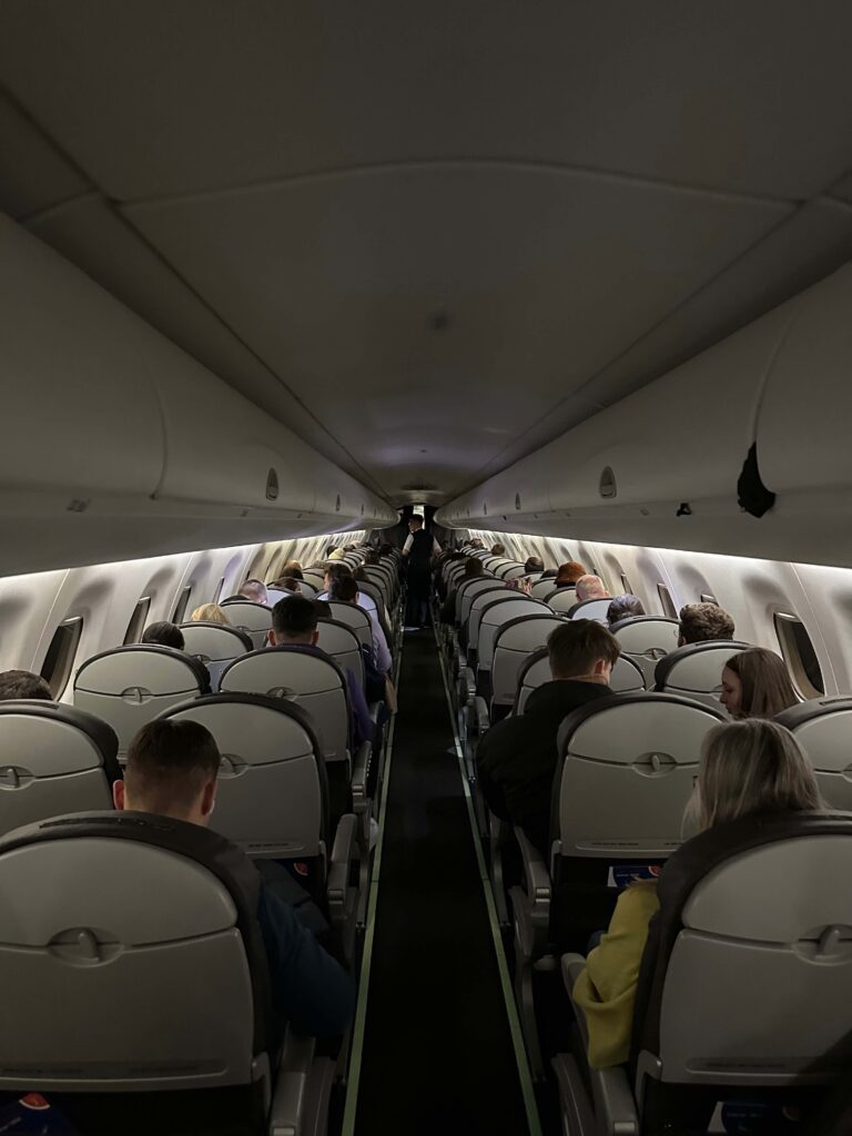 a group of people sitting in an airplane