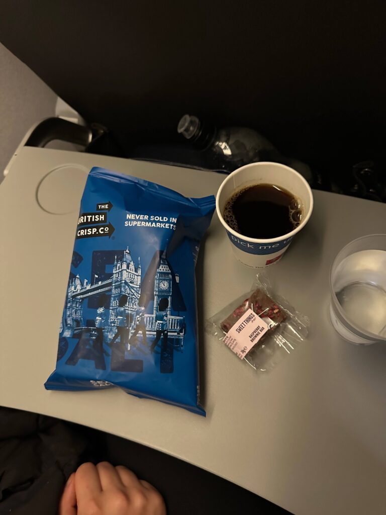 a bag of chips and a cup of coffee on a table