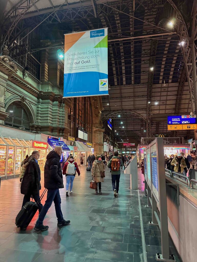 a group of people walking in a train station