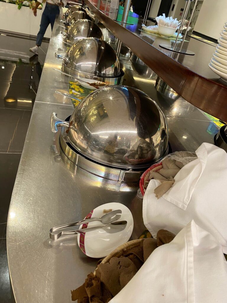 a row of silver food containers on a counter