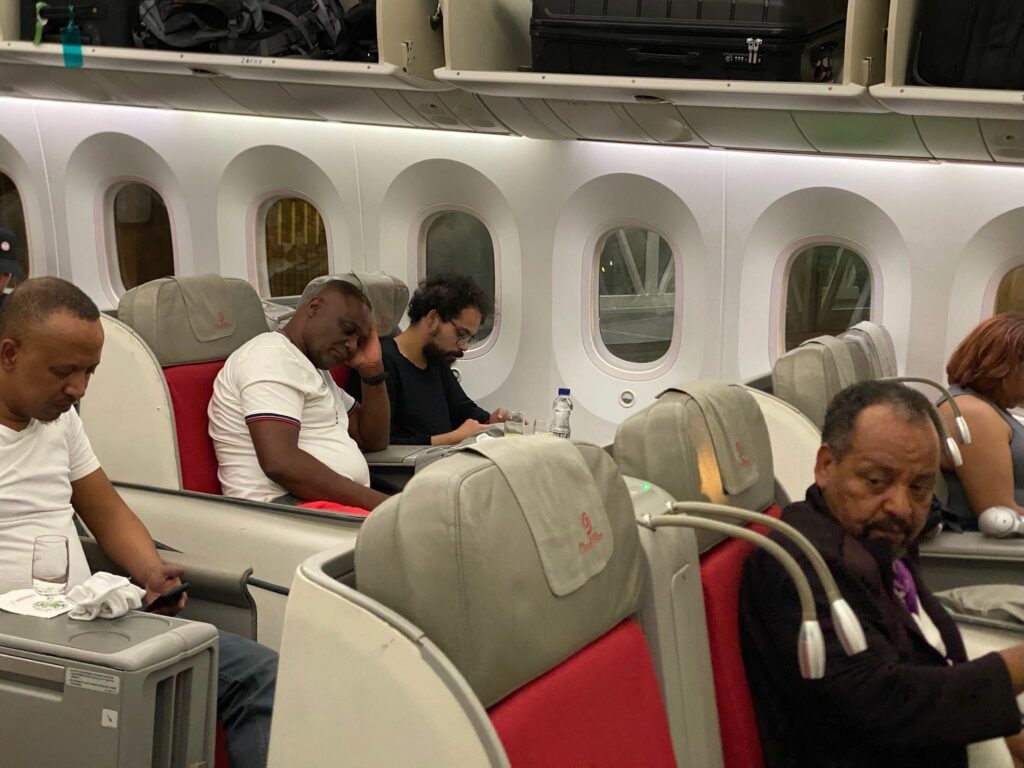 a group of men sitting on an airplane