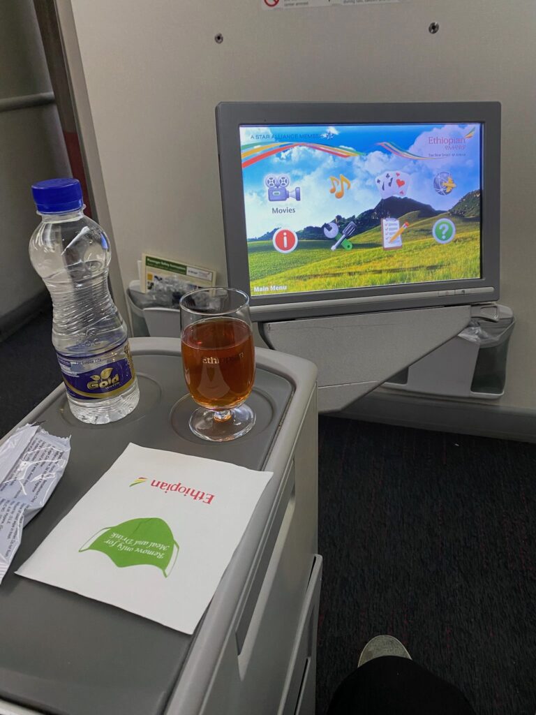 a computer screen and a drink on a table