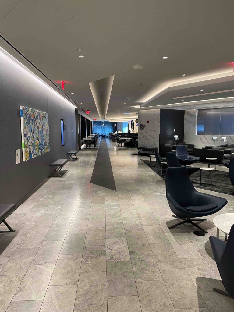 a long hallway with chairs and tables