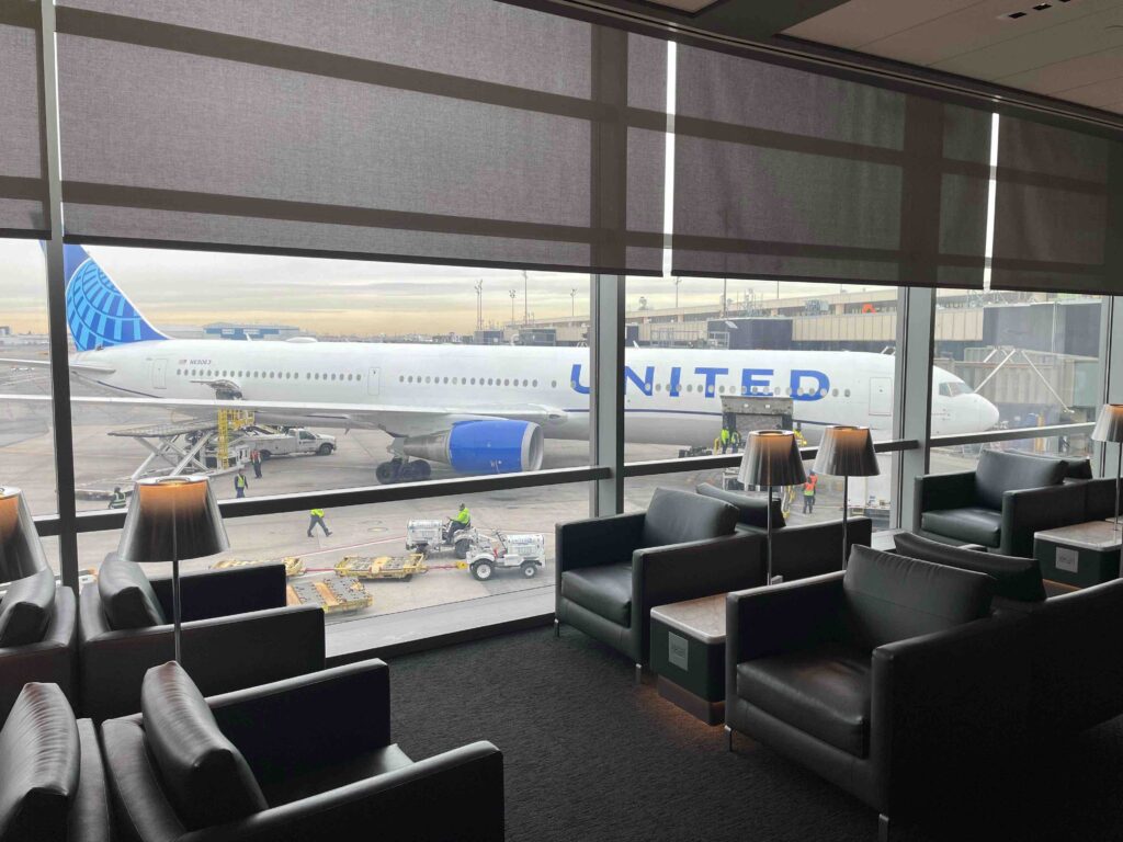 a large window with a plane in the background