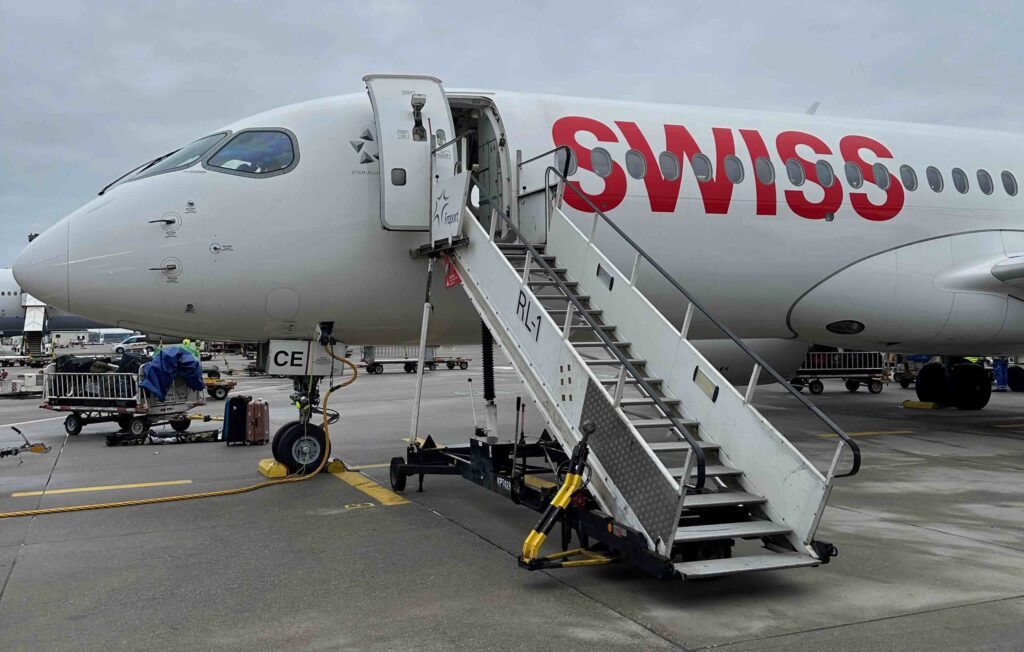a plane with stairs and a man in the background