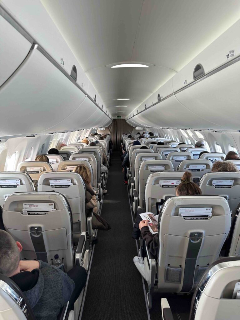 a group of people sitting in an airplane