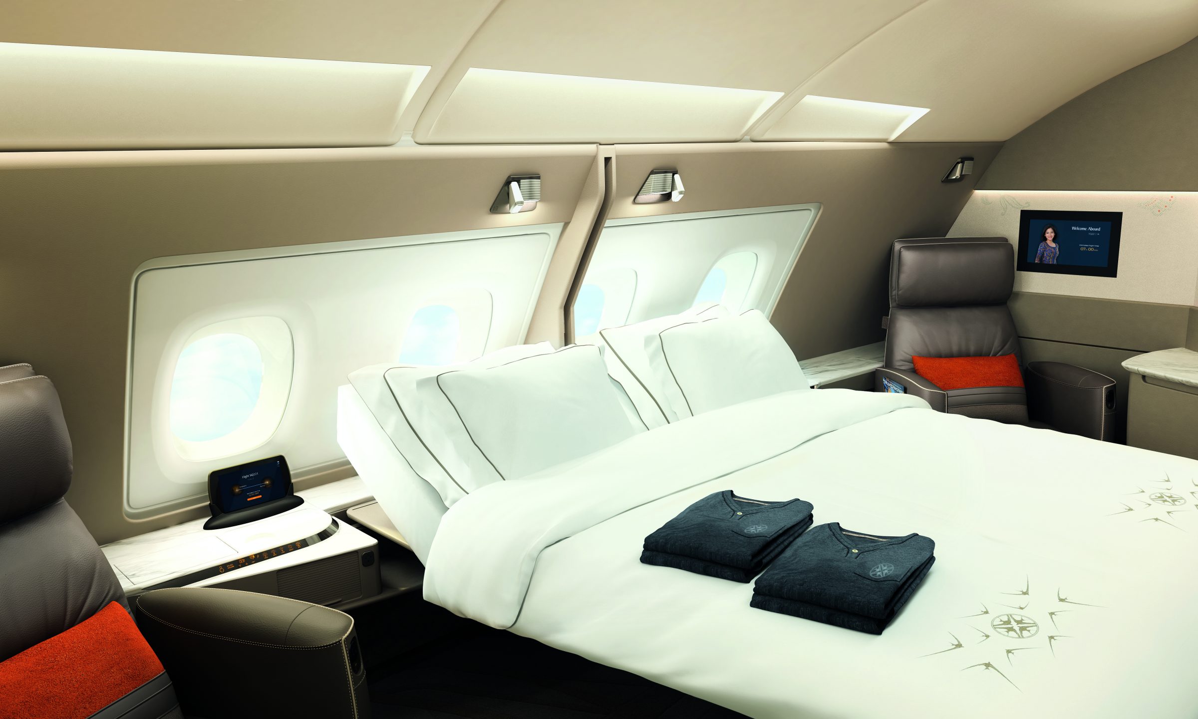 a bed with white sheets and pillows in an airplane