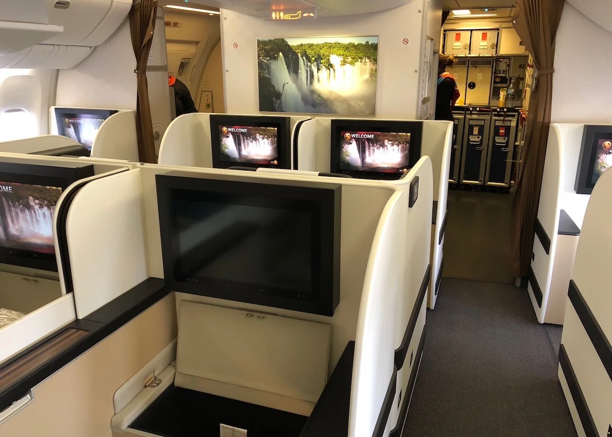 a row of seats with monitors on it