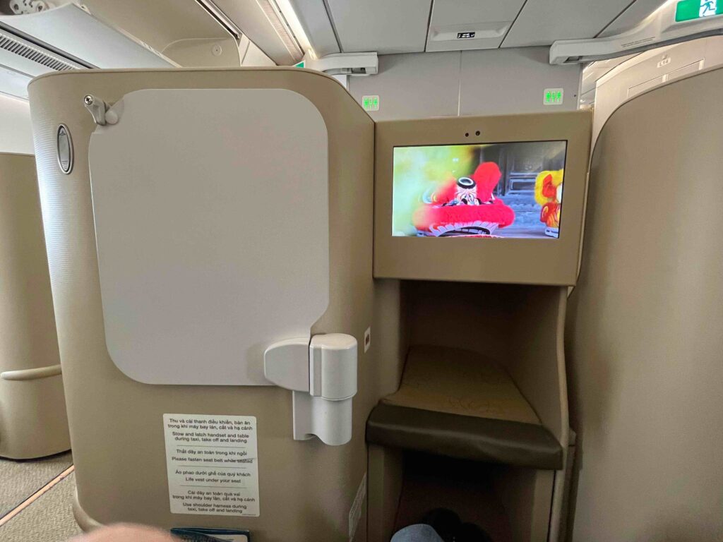 a tv on a screen in an airplane