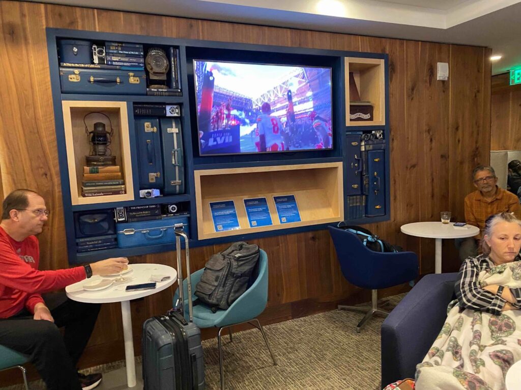 a person sitting at a table with a tv in front of them