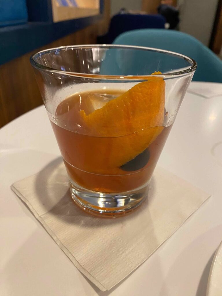 a glass with a drink and an orange slice