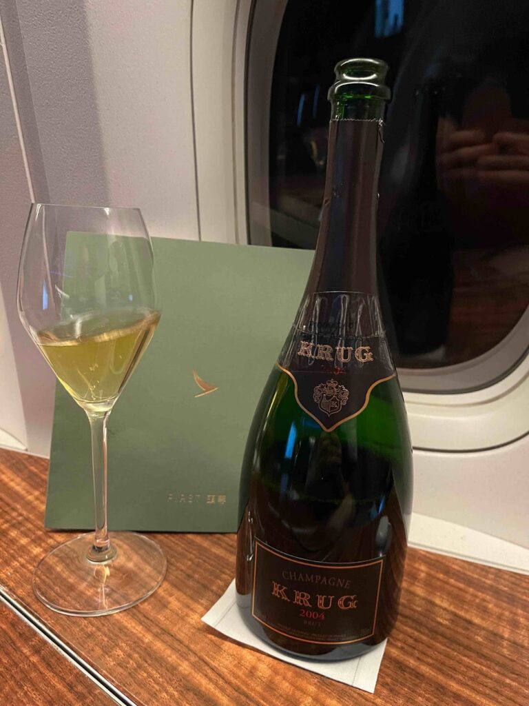 a bottle of champagne next to a glass of wine