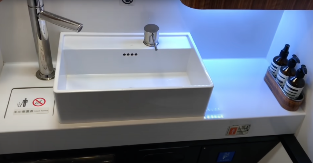 a white sink with a silver faucet