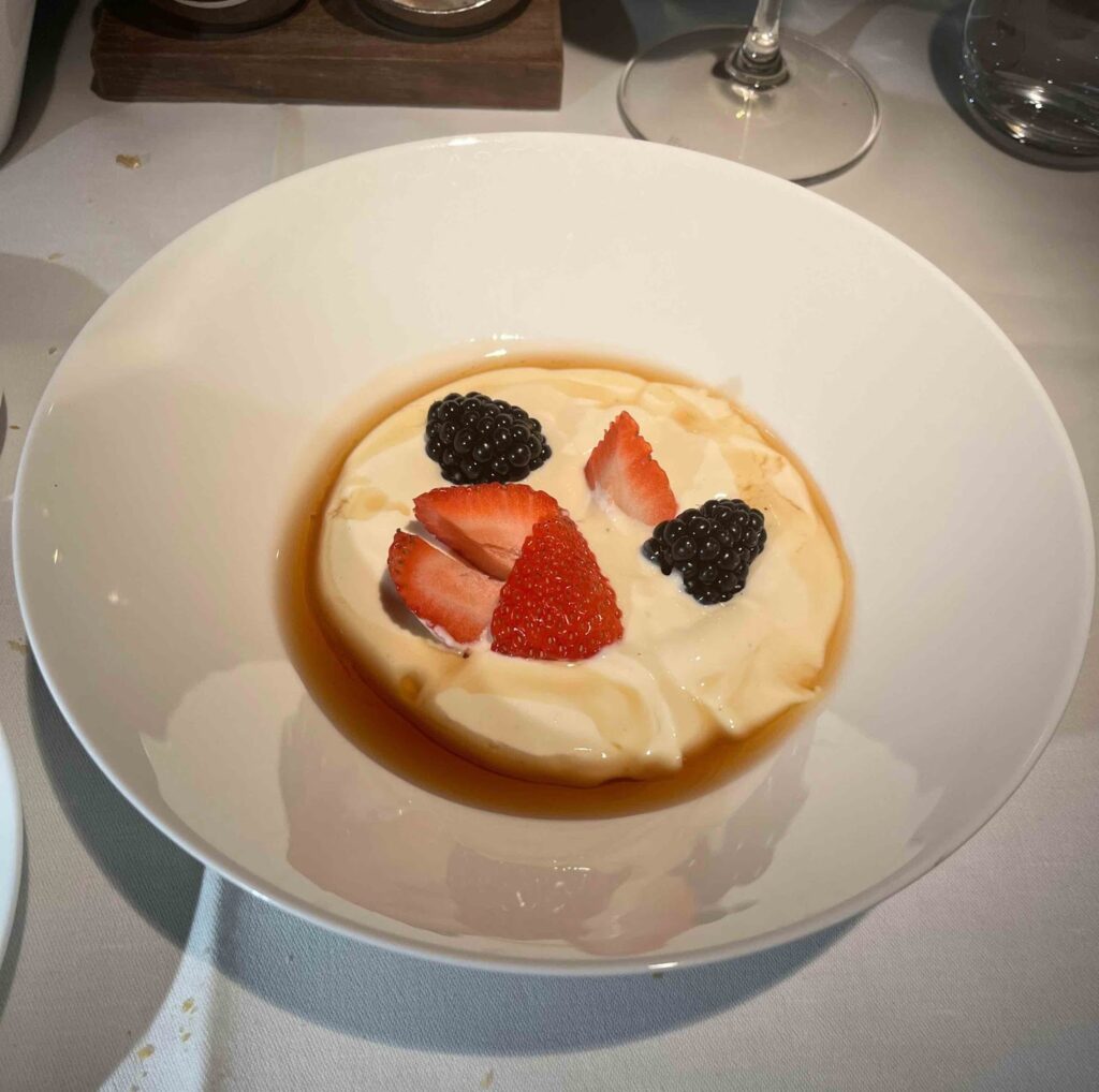 a bowl of food with strawberries and blackberries