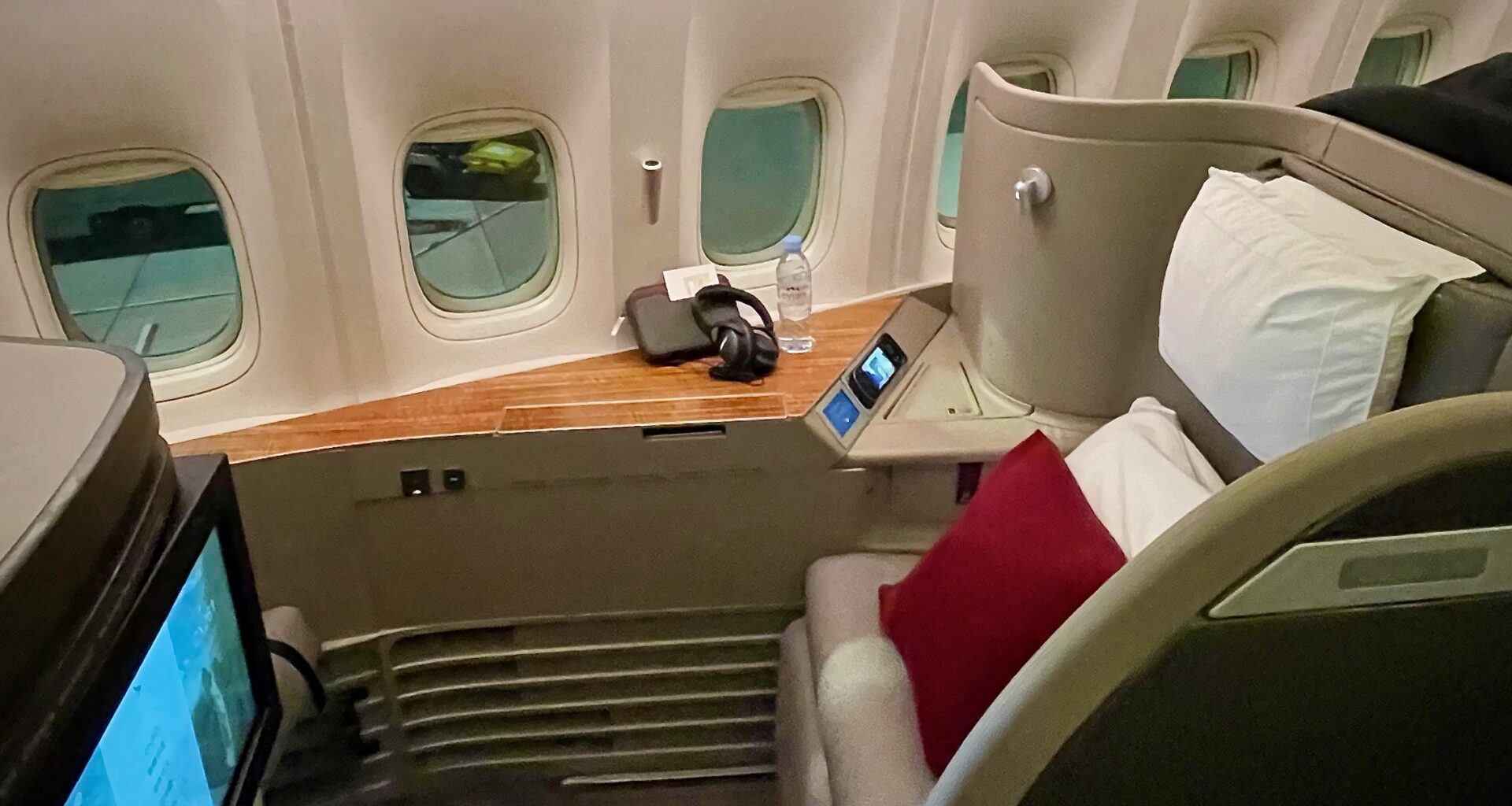 a seat with a headphone and a bottle on the side of the seat