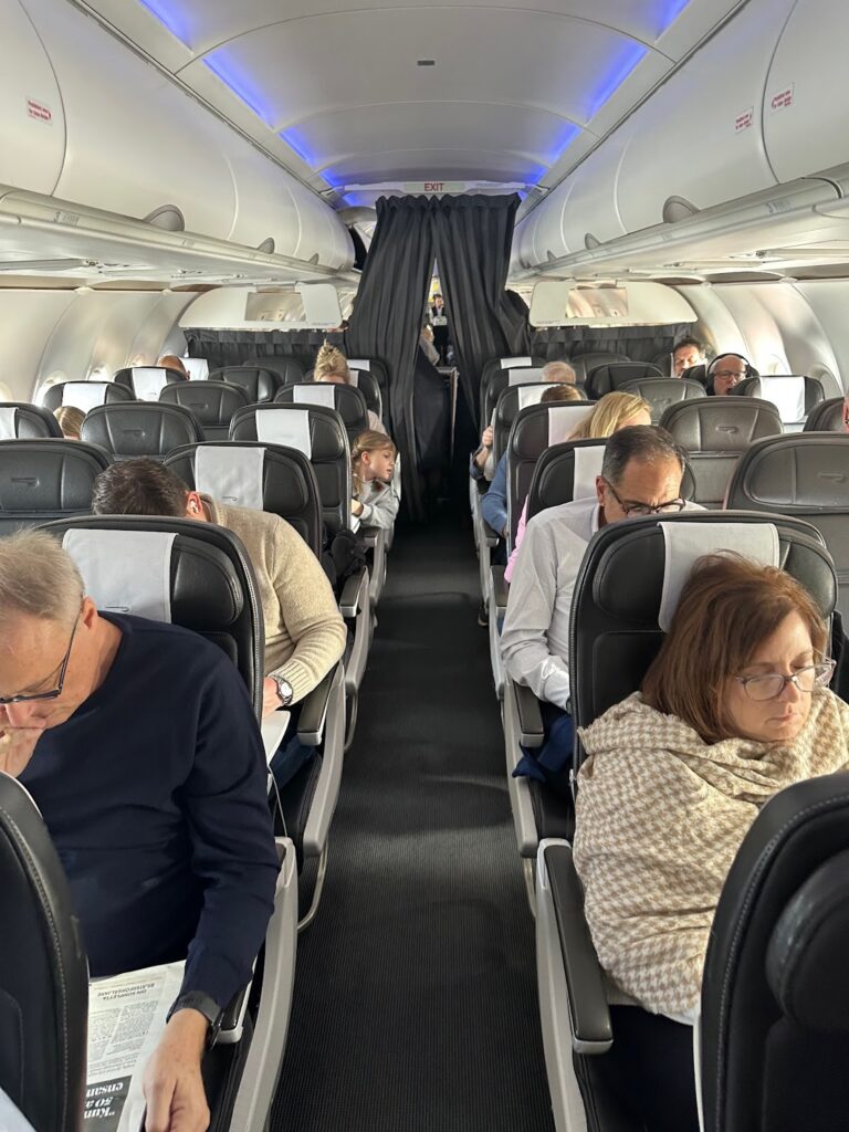 a group of people sitting in an airplane