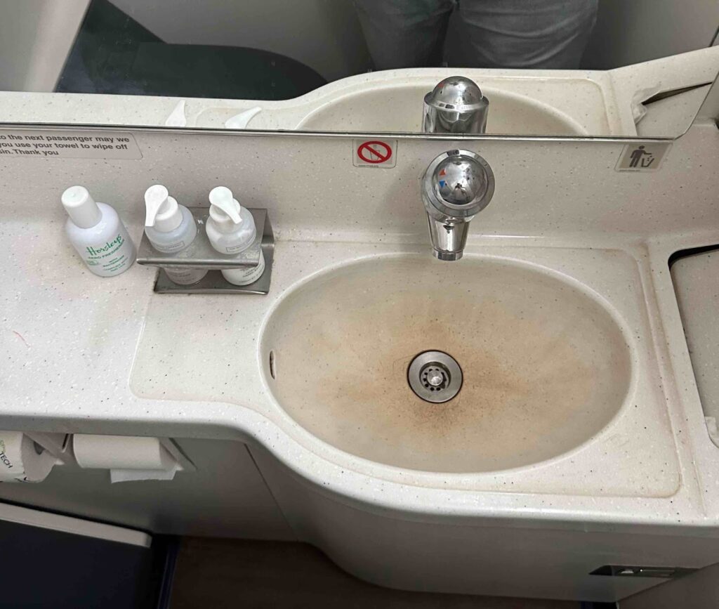 a sink with soap and soap dispenser