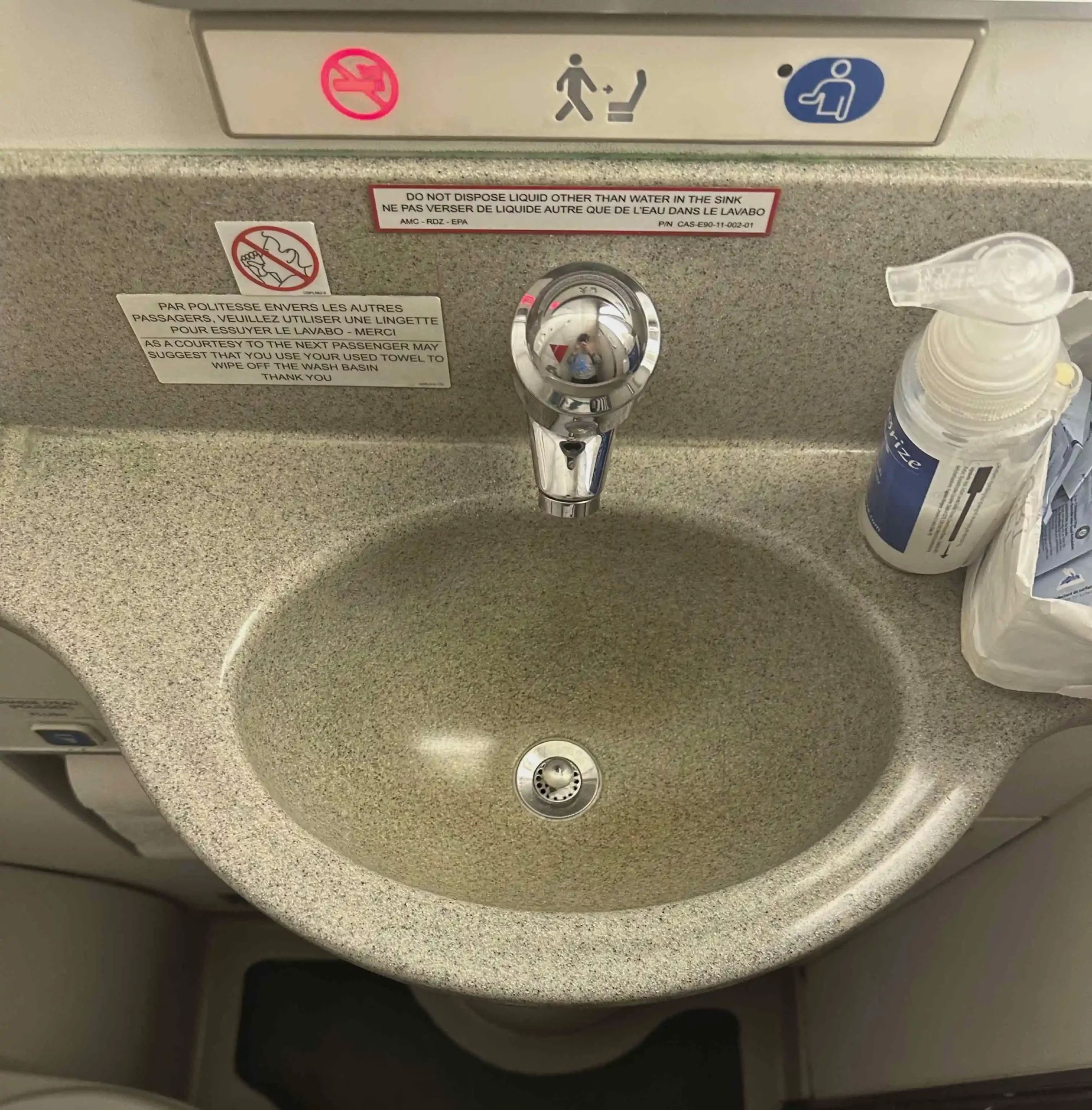 a sink with a soap dispenser and a bottle of soap