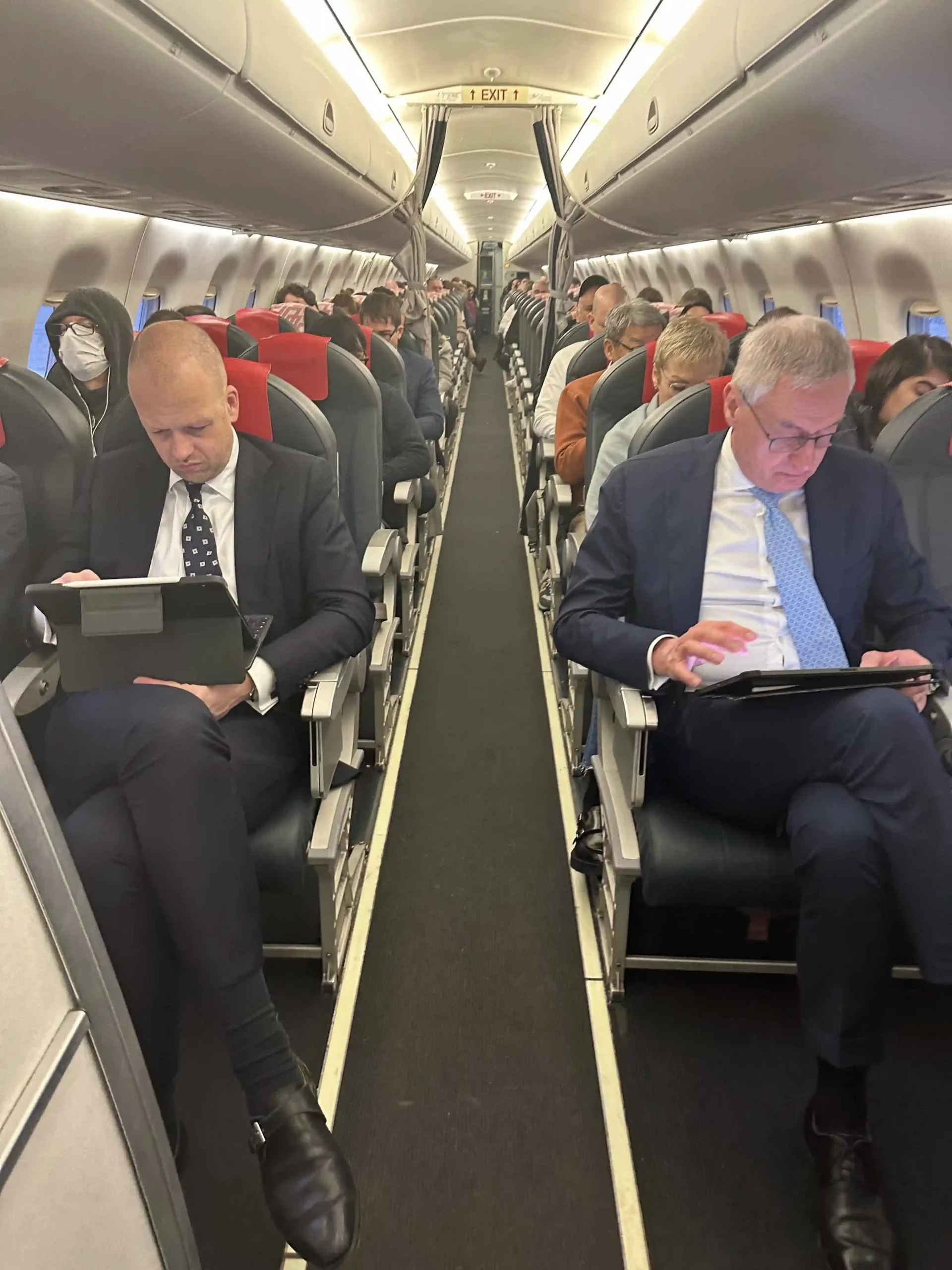 a group of people sitting on an airplane