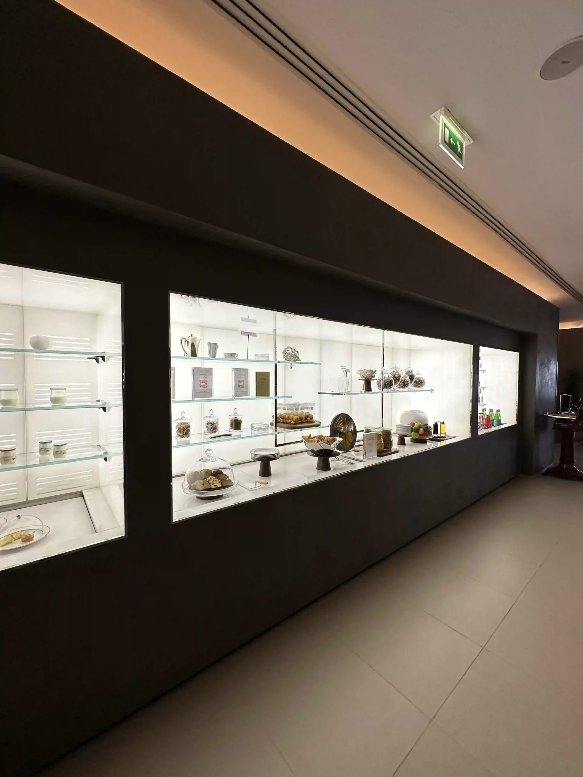 a display case with glass shelves and plates on it