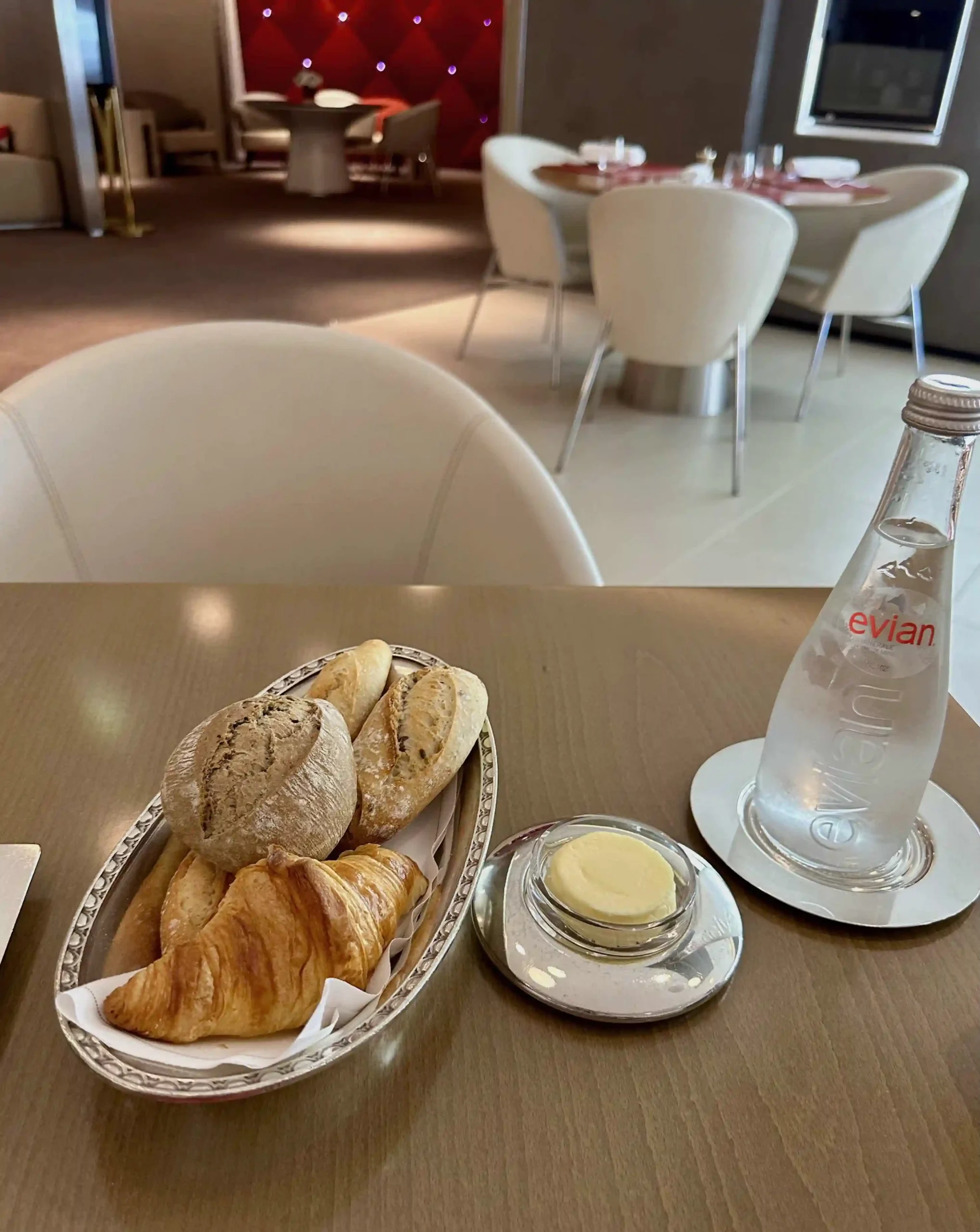 a table with a bowl of bread and a bottle of water