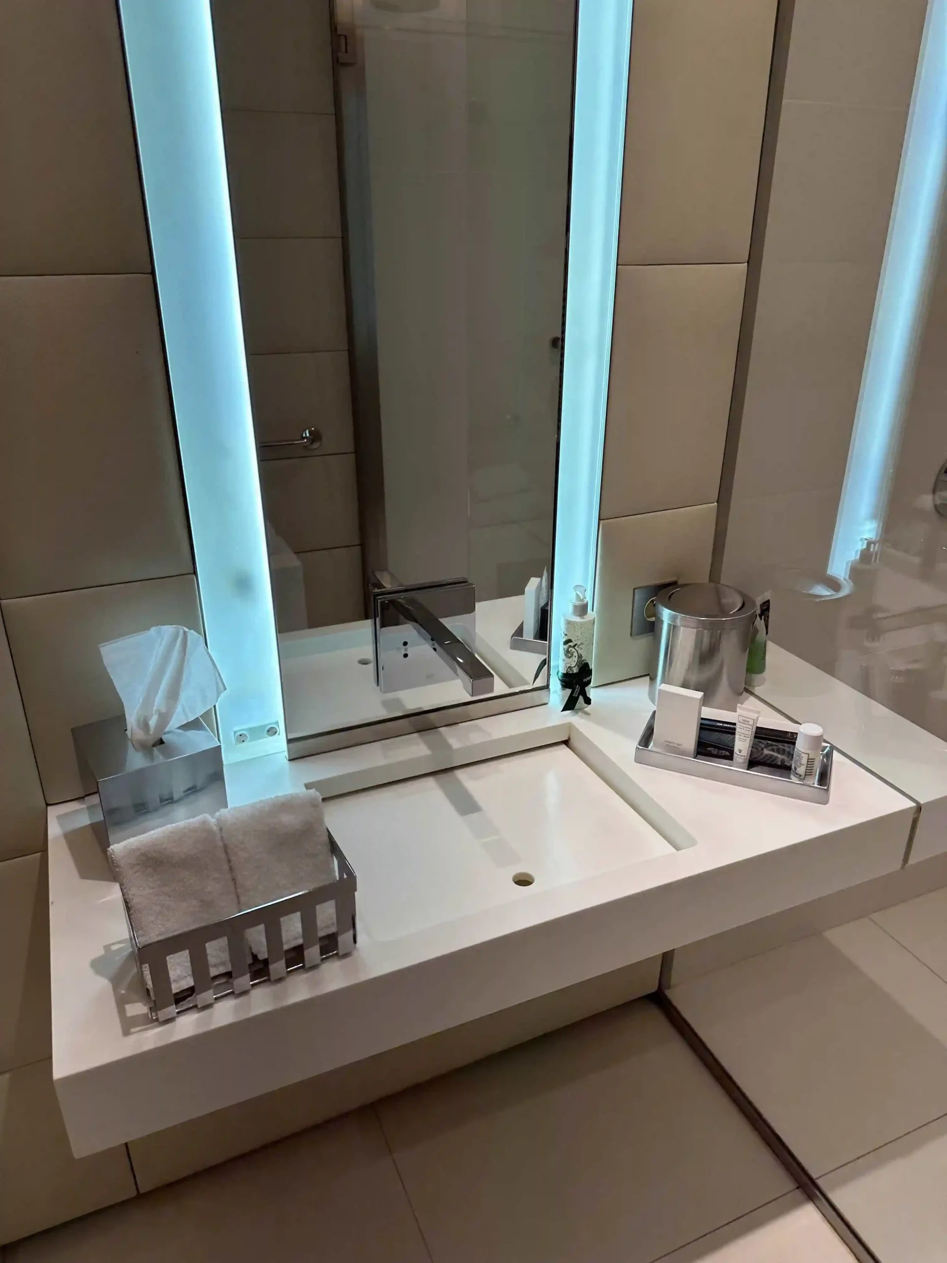 a bathroom sink with a mirror and a tray