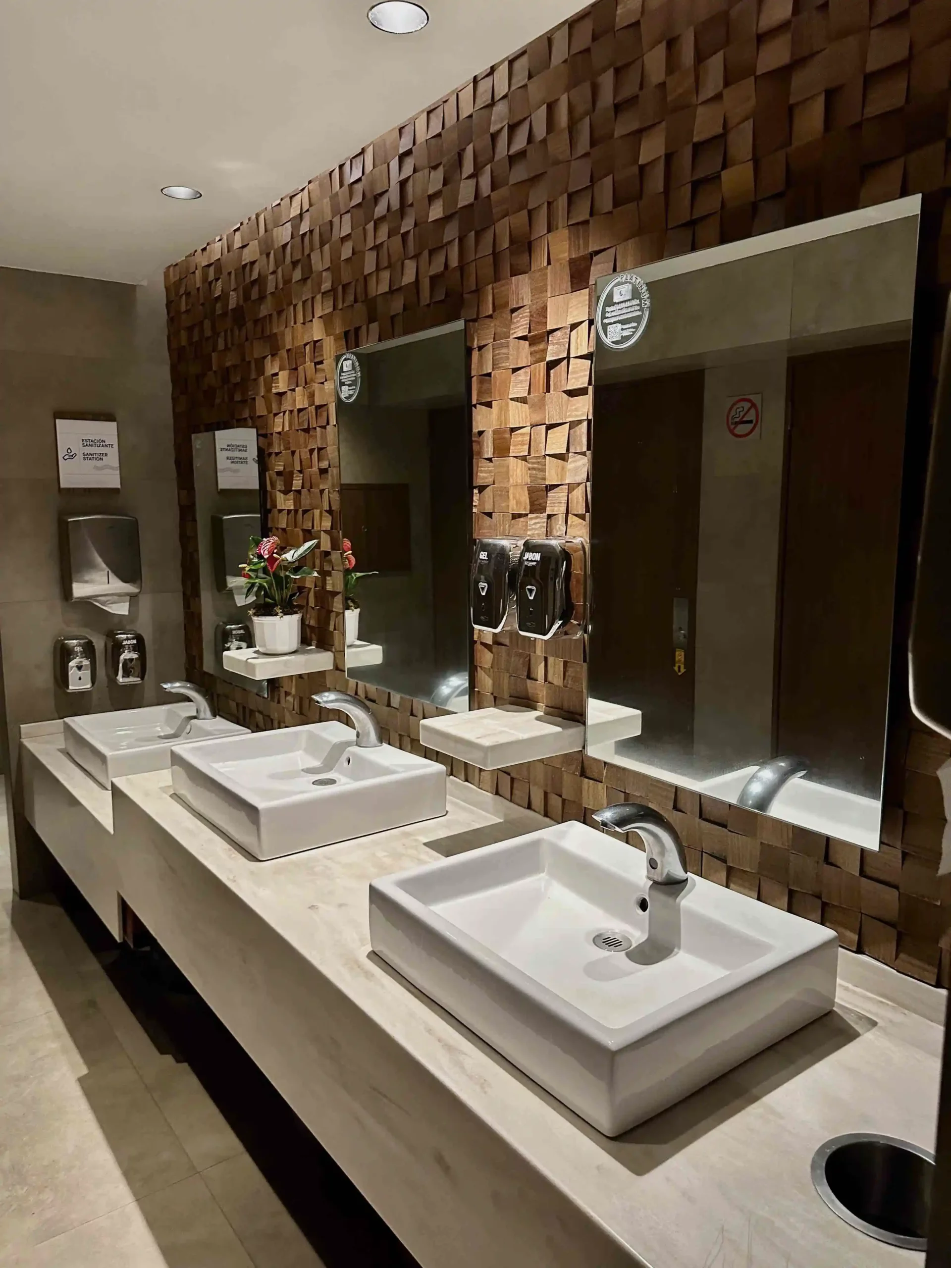 a bathroom with sinks and mirrors
