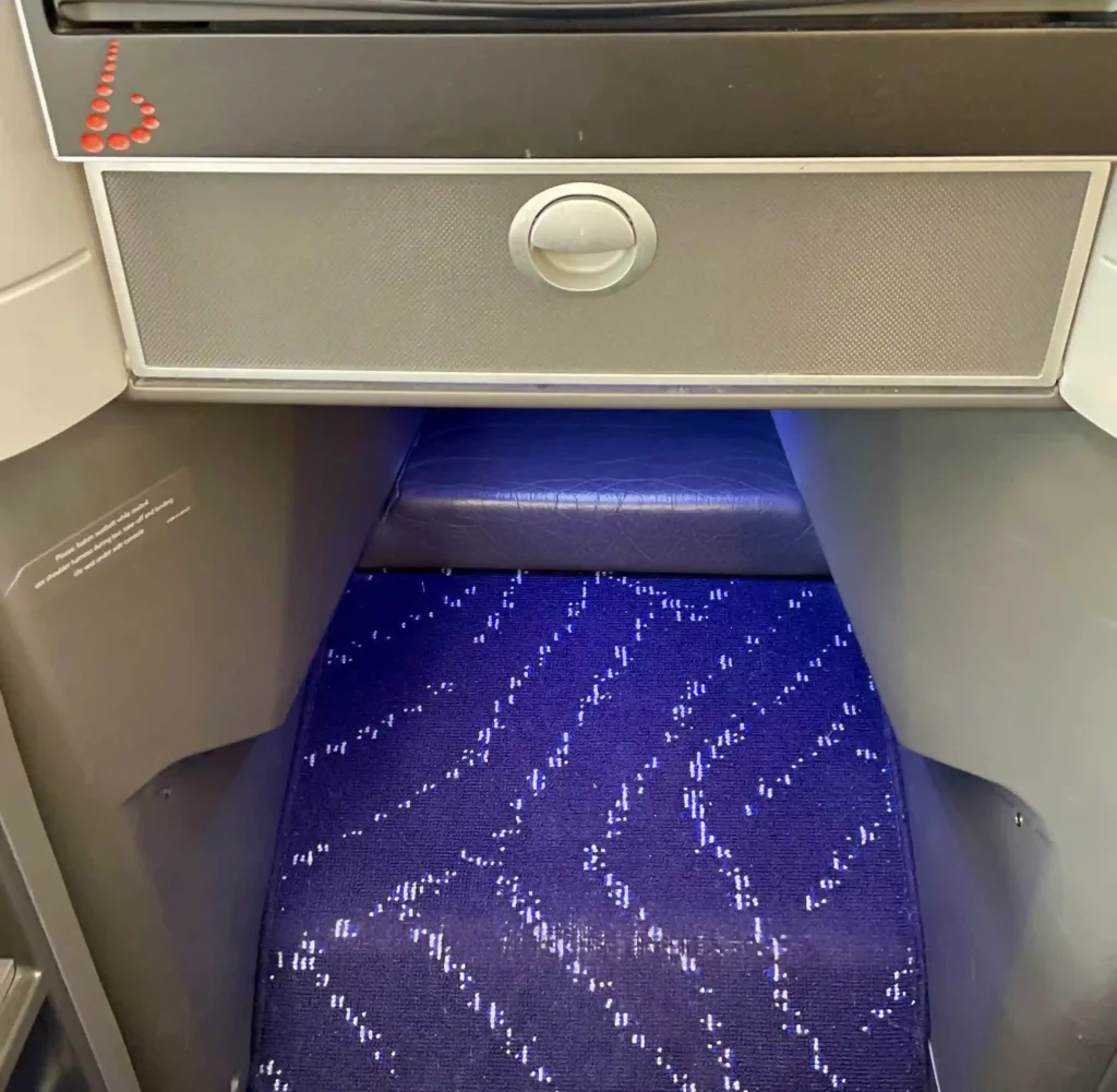 a blue carpet under a seat