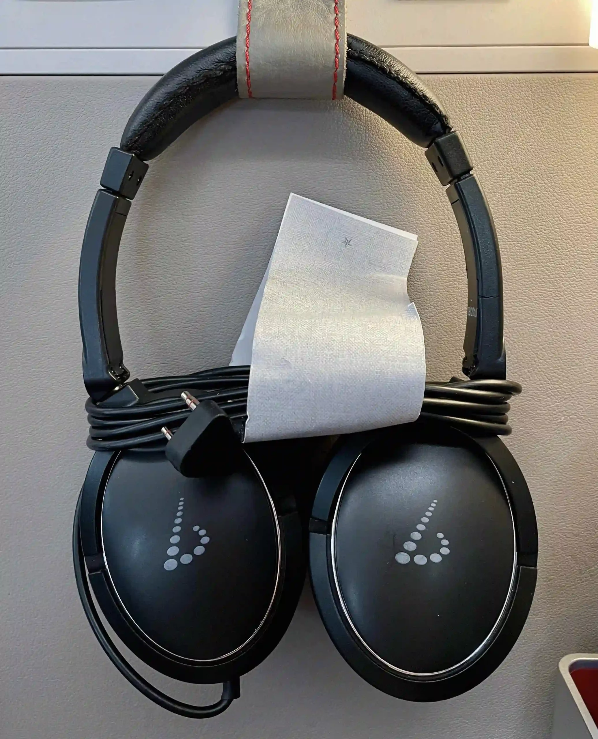 a pair of black headphones with a roll of paper