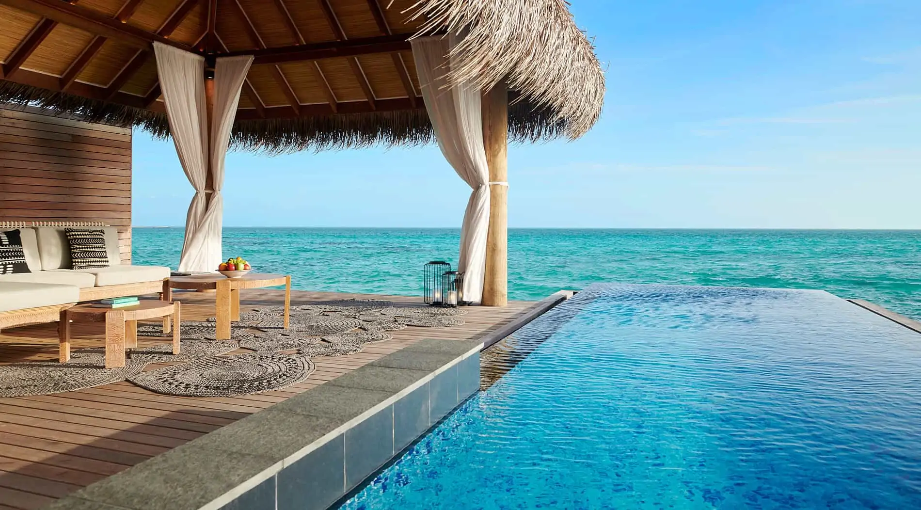 a pool with a table and chairs on it