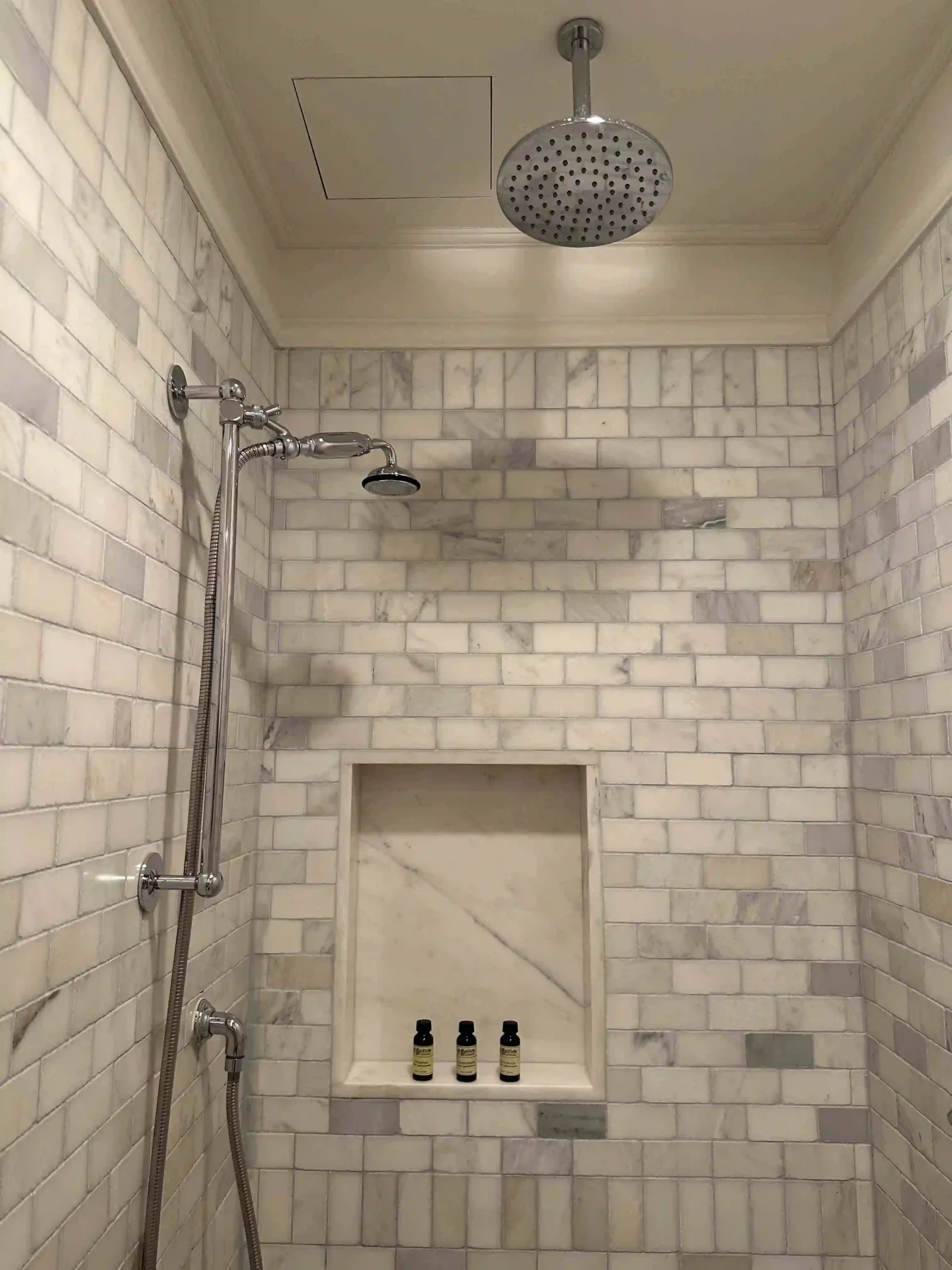 a shower with a shower head and a shower head