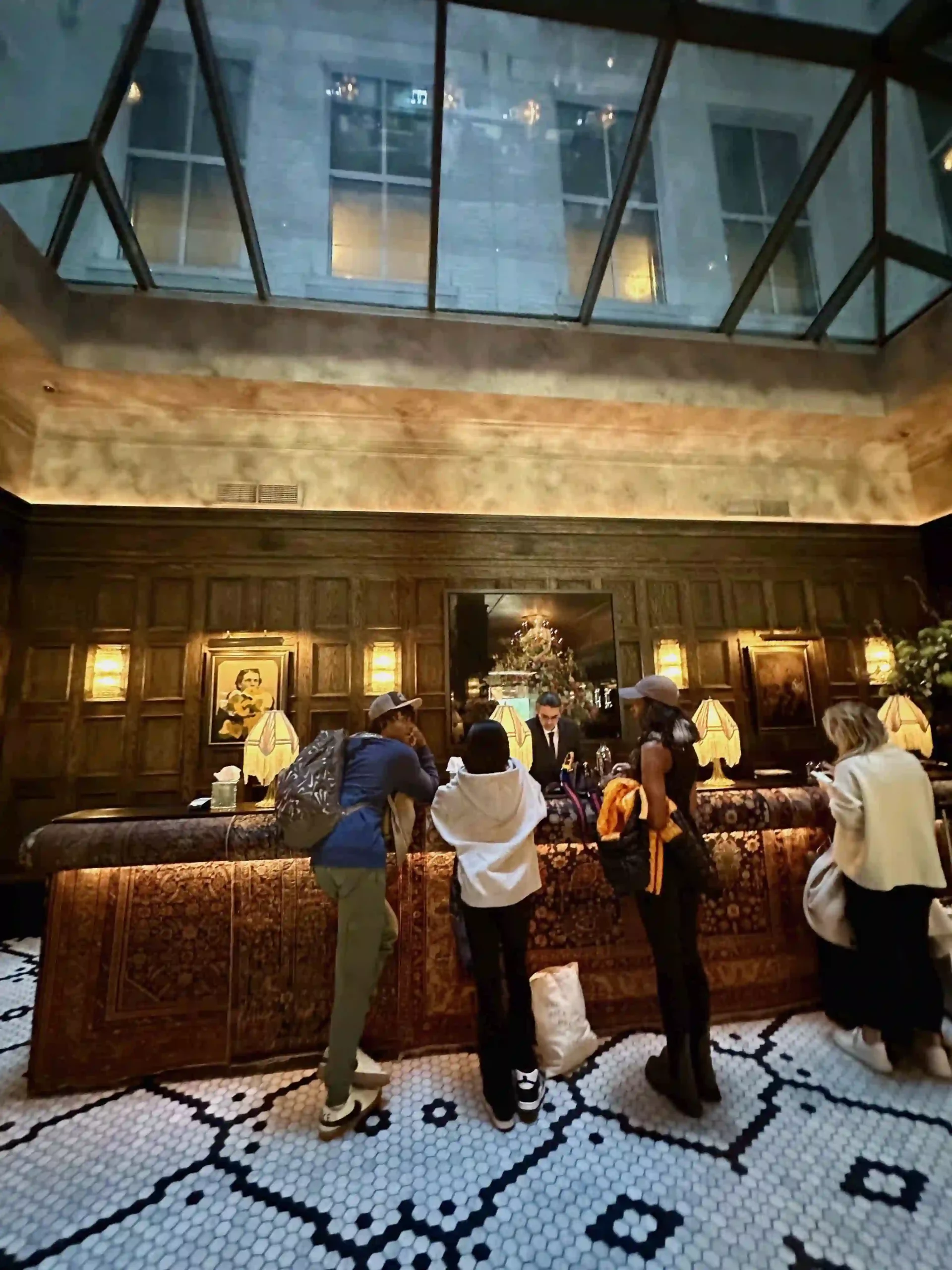 a group of people standing at a counter in a hotel