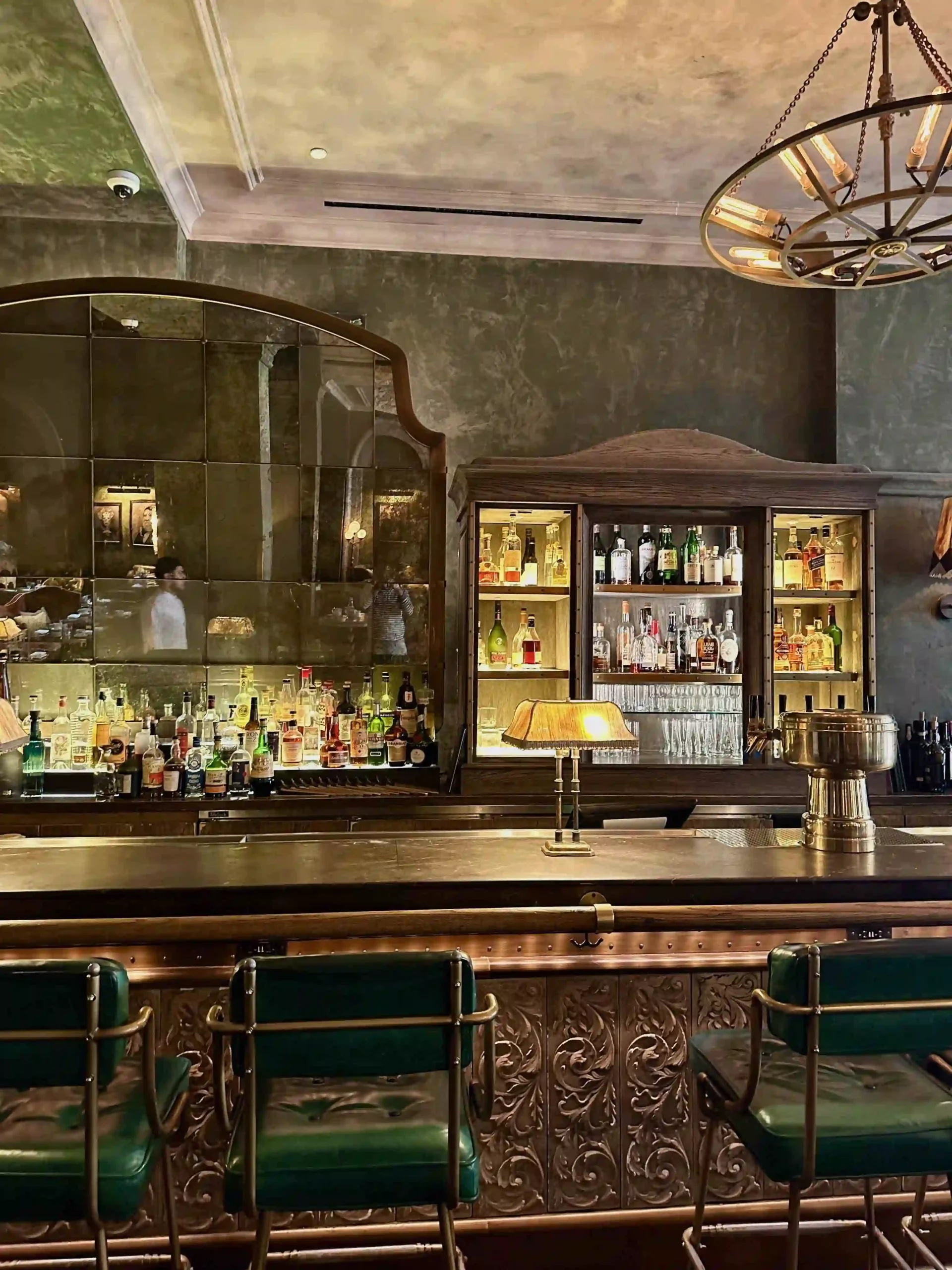 a bar with a mirror and a bar counter