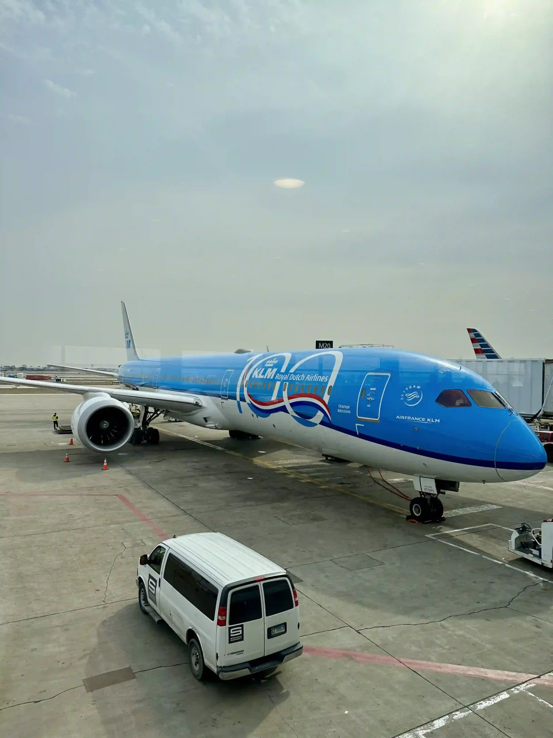 a blue and white airplane on a tarmac