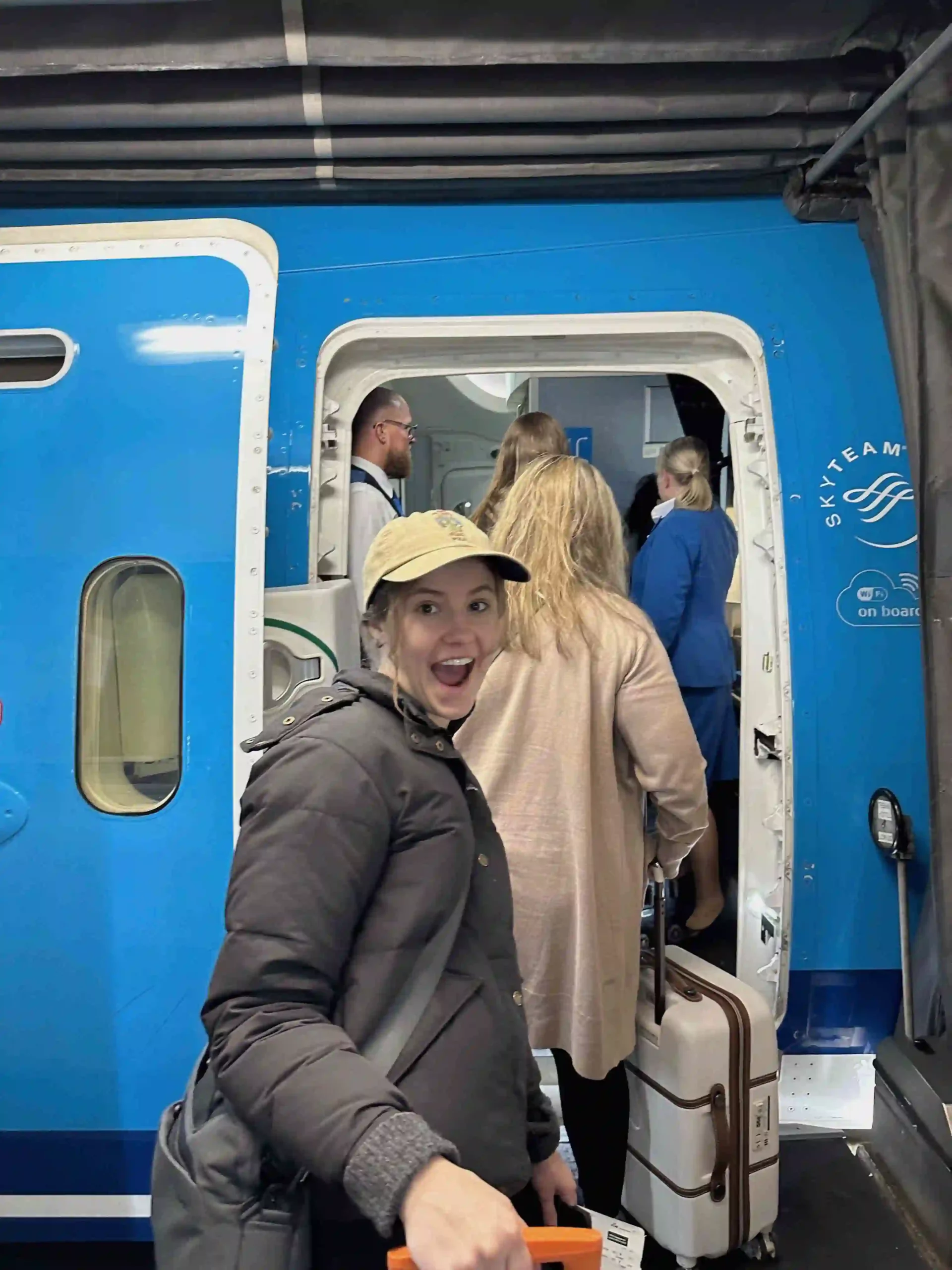 a woman standing in front of a blue train