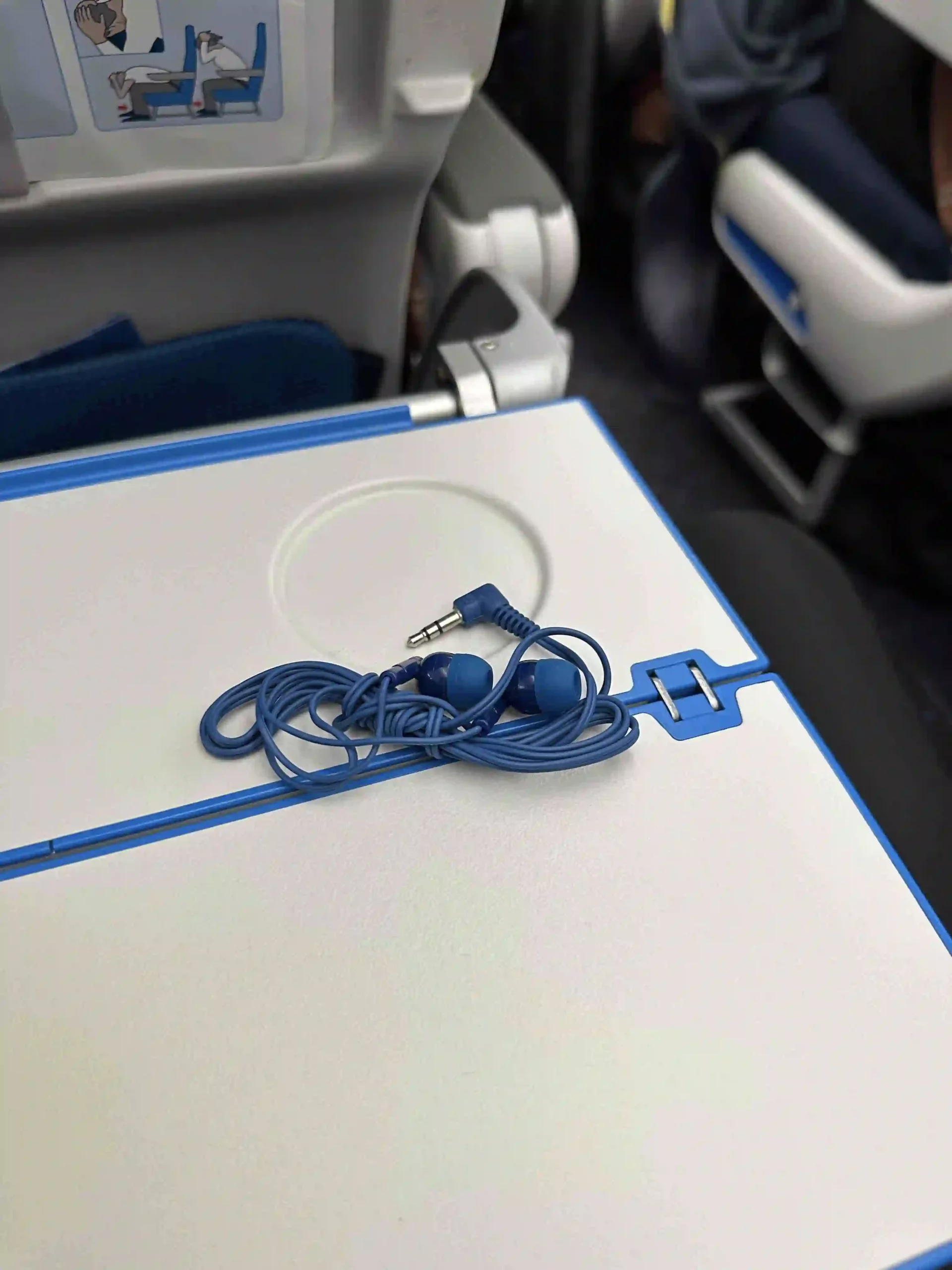 a blue earbuds on a white surface