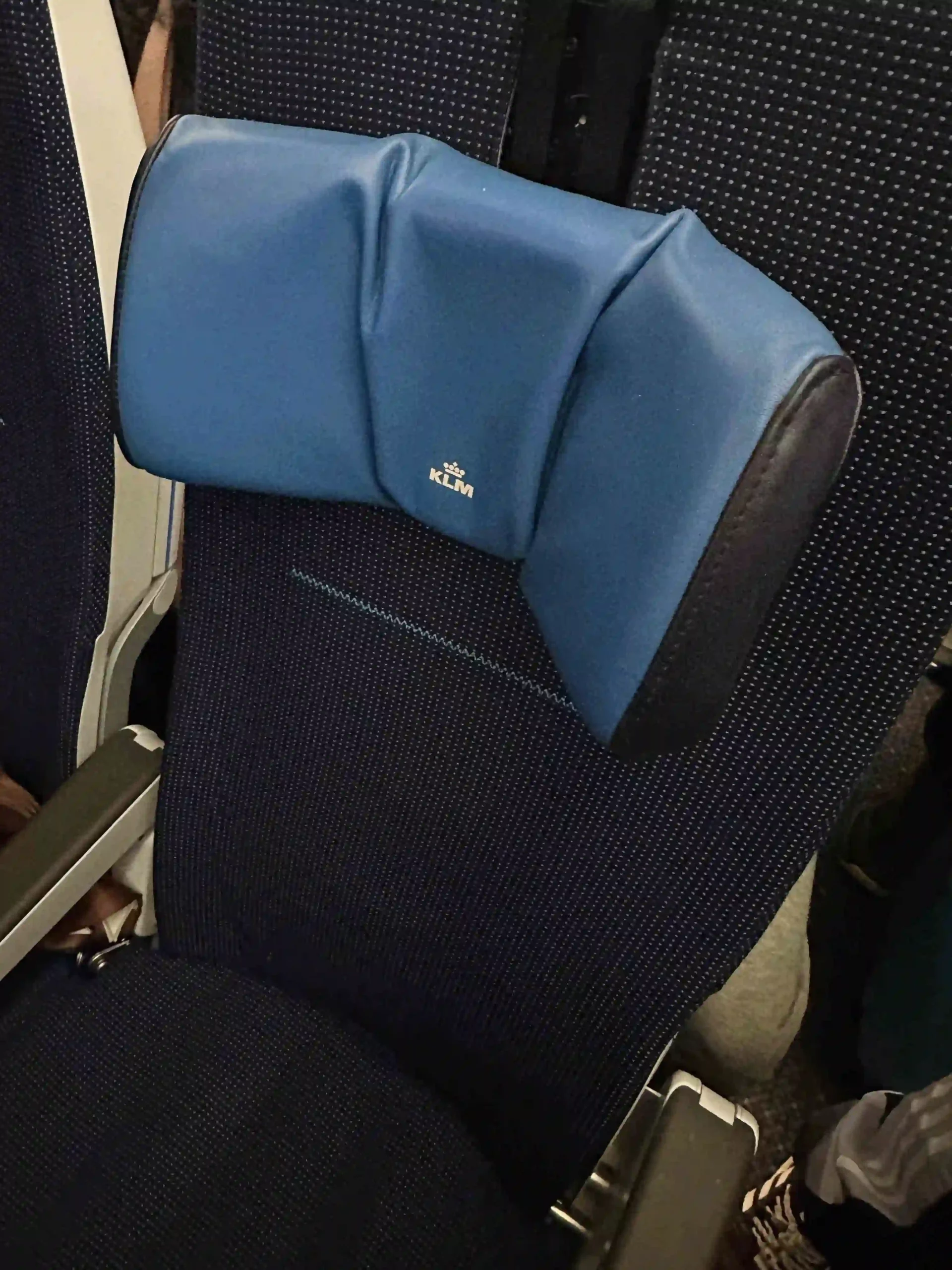 a blue head rest on a seat