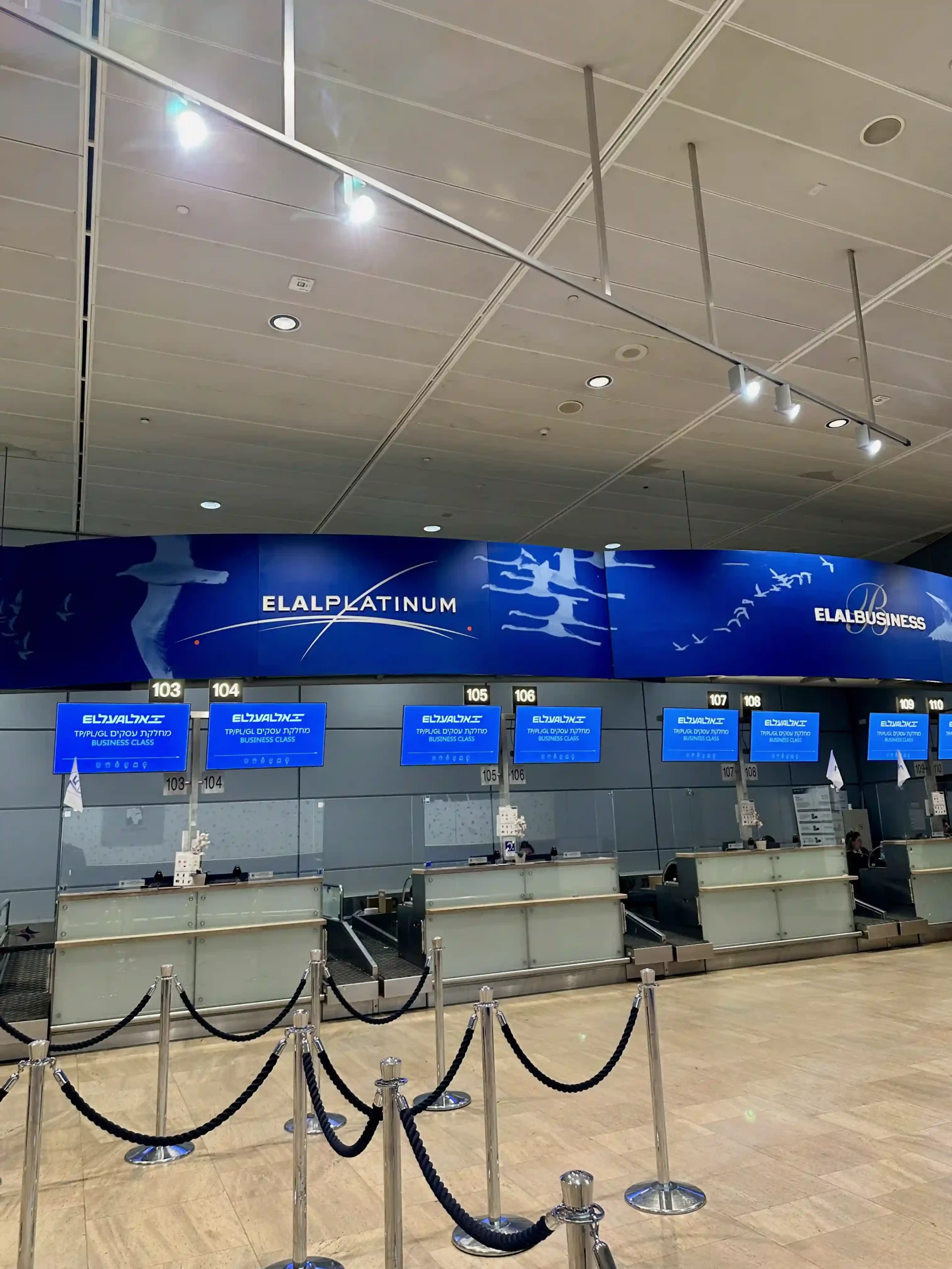 a row of blue signs in a airport