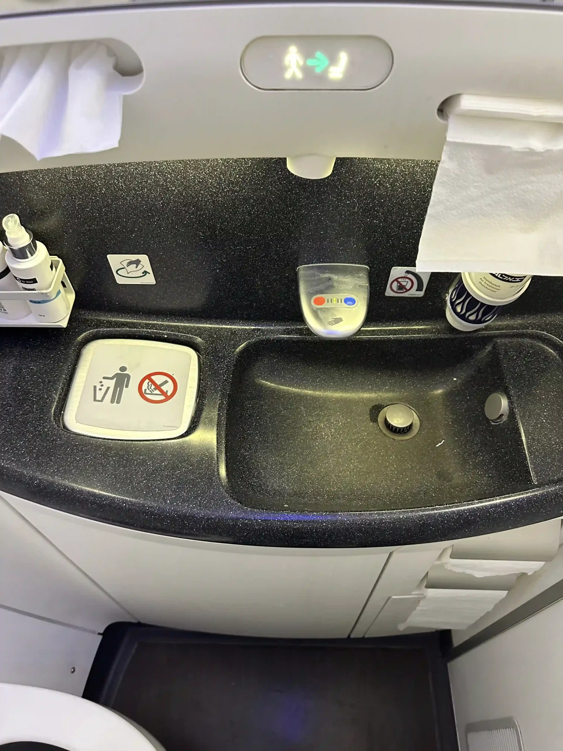 a sink with a black counter top