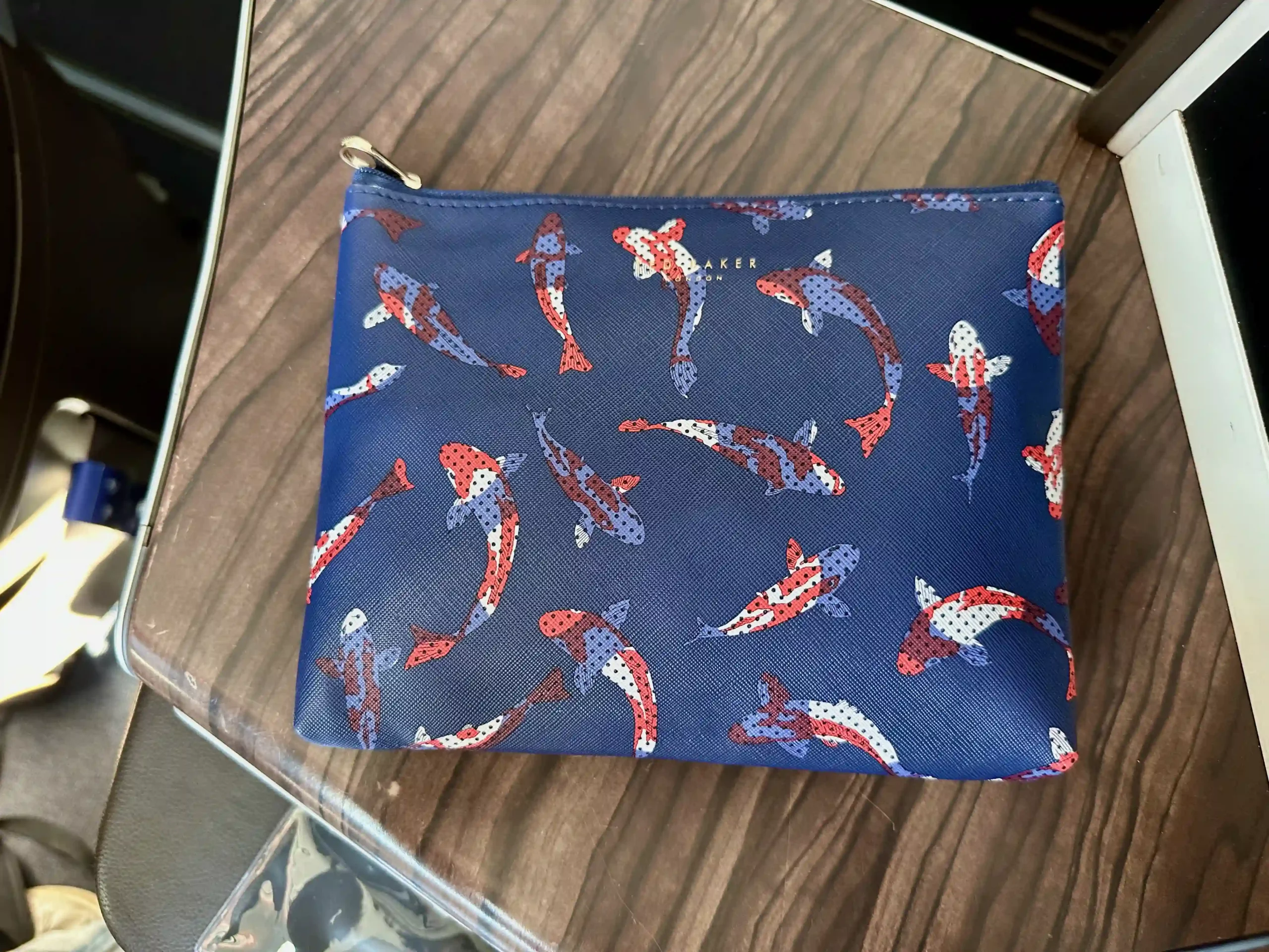a blue purse with fish pattern on it